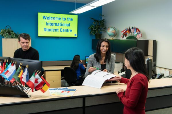 Student being helped at the front desk of the International Student Centre