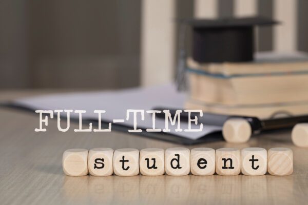 Words FULL-TIME STUDENT composed of wooden dices.