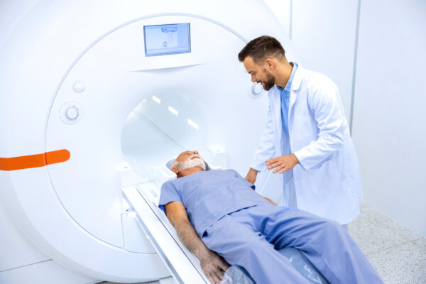 MRI Technician assisting patient into MRI Machine