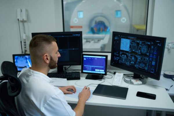 MR tech performing magnetic resonance imaging of head