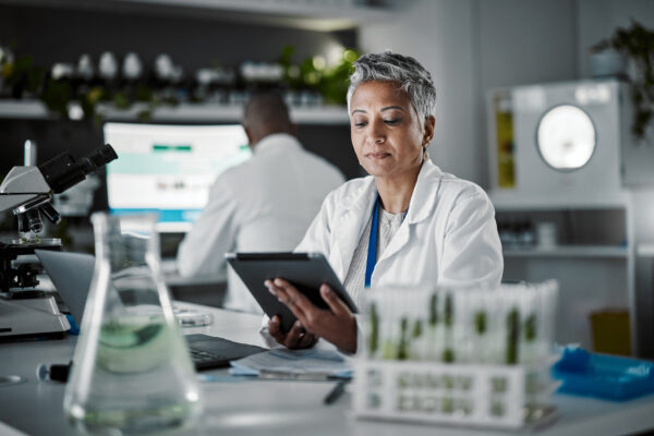 Food Technologist in lab coat with iPad