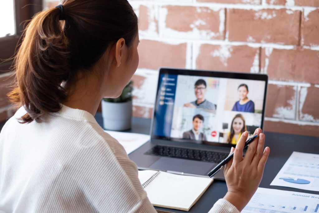 Young businesswoman work at home and virtual video conference meeting with colleagues business people, online working, video call due to social distancing at home office