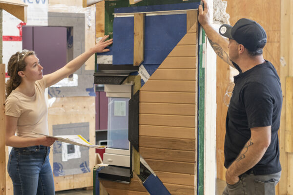 BCIT Students at the Zero Energy/Emissions Building Learning Centre eexamining a real wall assemby that would meet the passive house standard.