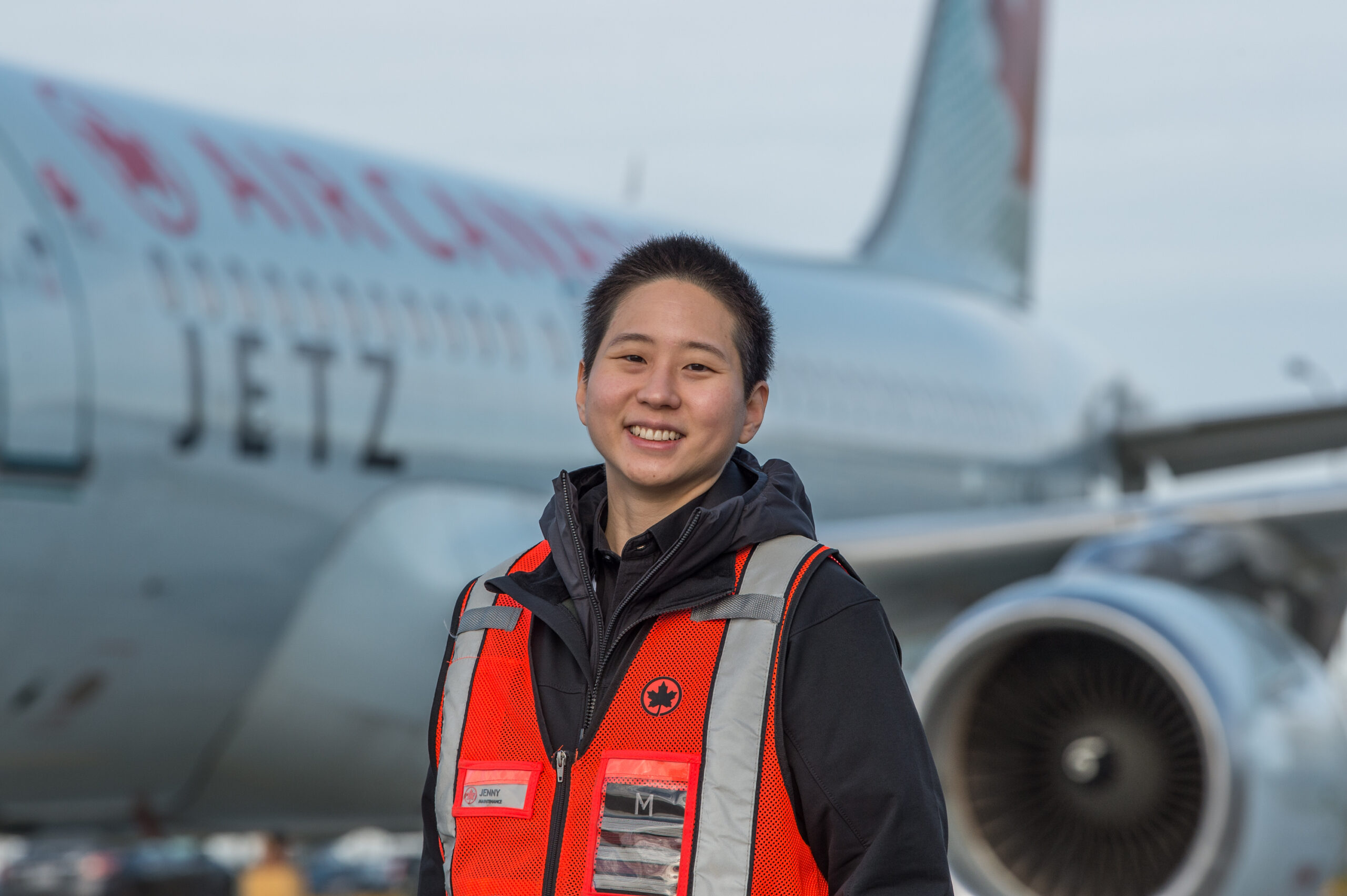 Jenny in the airport runway in a safety vest