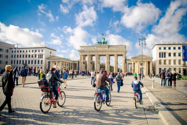 People cycling near Brandenburg Gate, Berlin, Germany