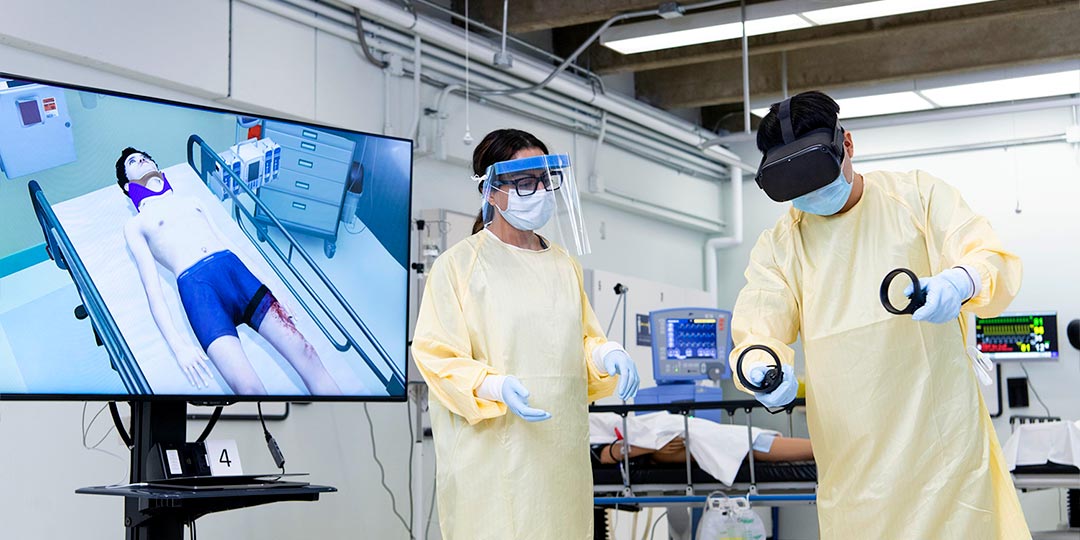 health sciences instructor teaching student with virtual reality headset in simulation lab