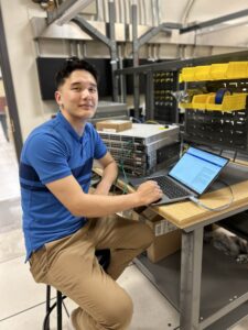 guy in blue shirt going on laptop