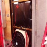 A blower door used for envelope air-tightness testing installed within a doorframe