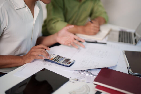 2 person team working on cost estimation and resource allocation for a building project.