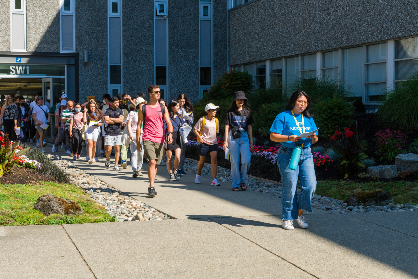New students following a student employee as they walk around the Burnaby campus.