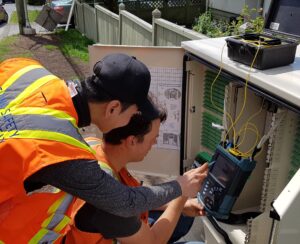 two students testing fiber optics connection