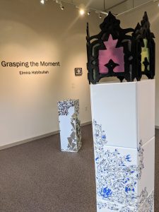 Elly's ceramic art on display in a gallery.