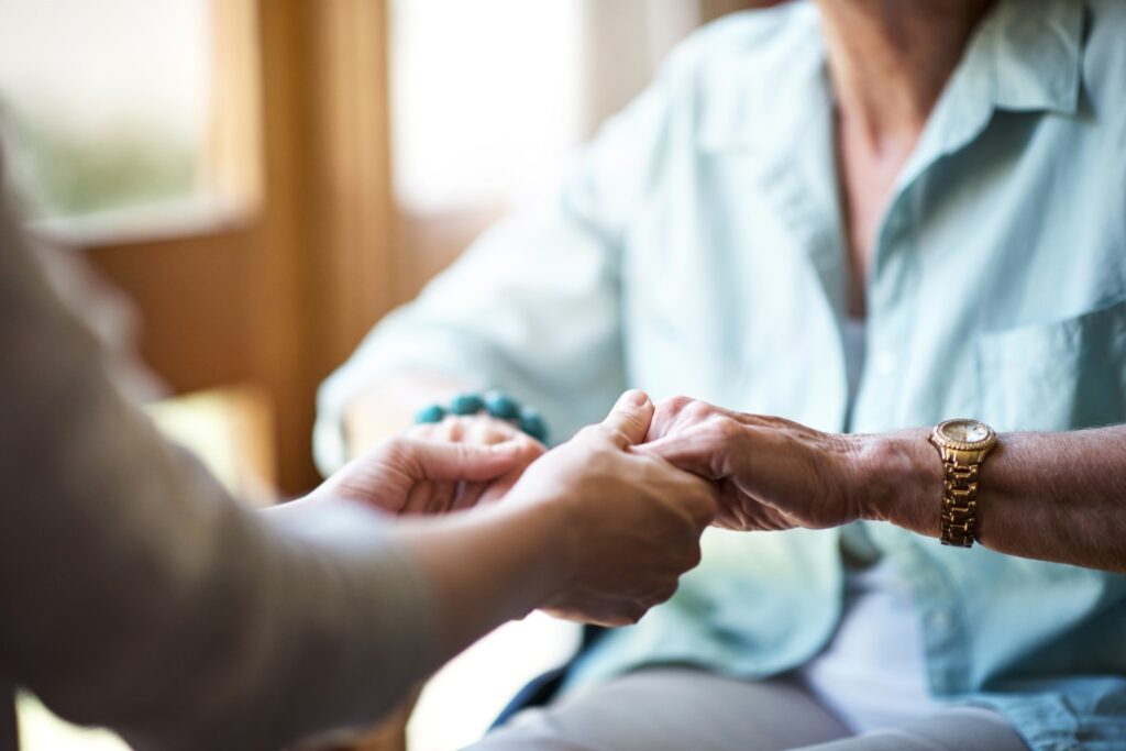 Nurse holding hands of patient