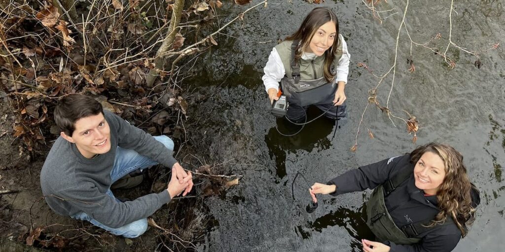 Students standing in water