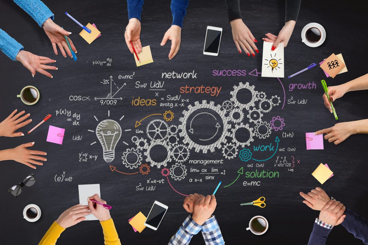 brainstorming board with gears and lightbulbs