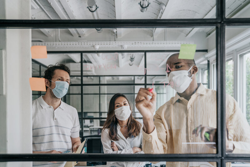 Businesspeople brainstorming work during the Covid-19 pandemic