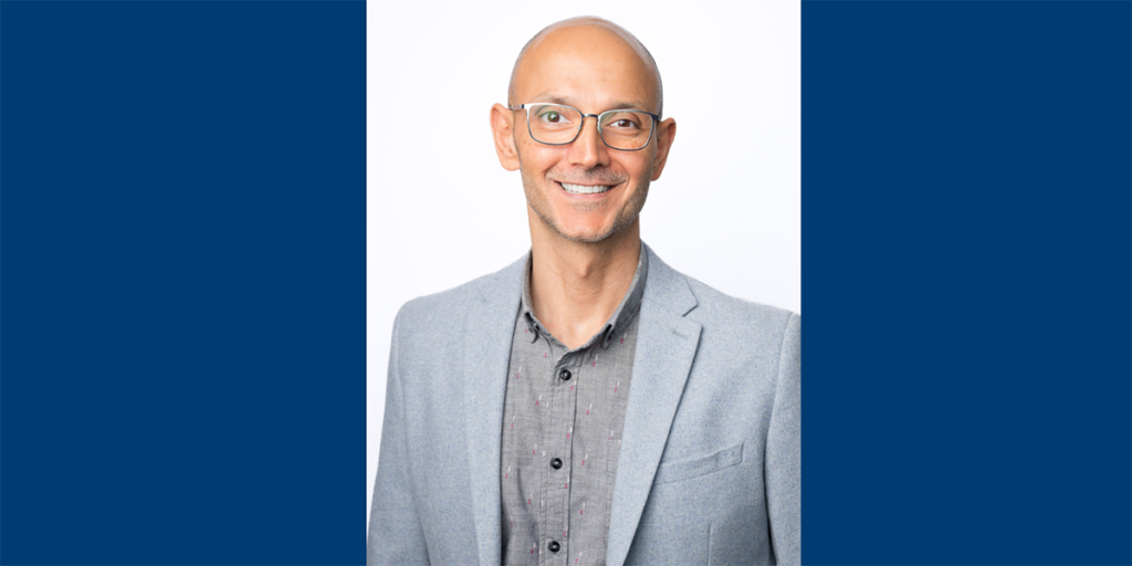 Sam Issari in a suit and glasses