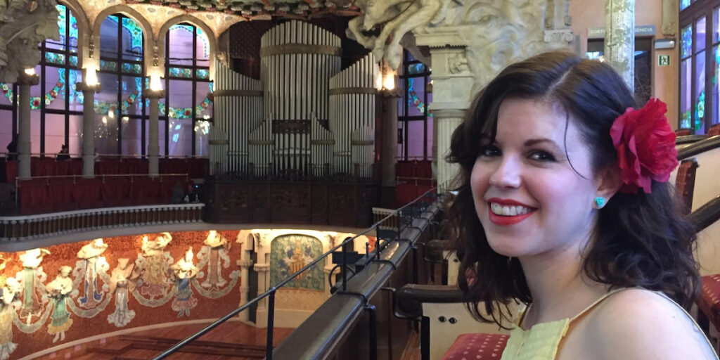 Julie in a theatre with a red flower in her hair.