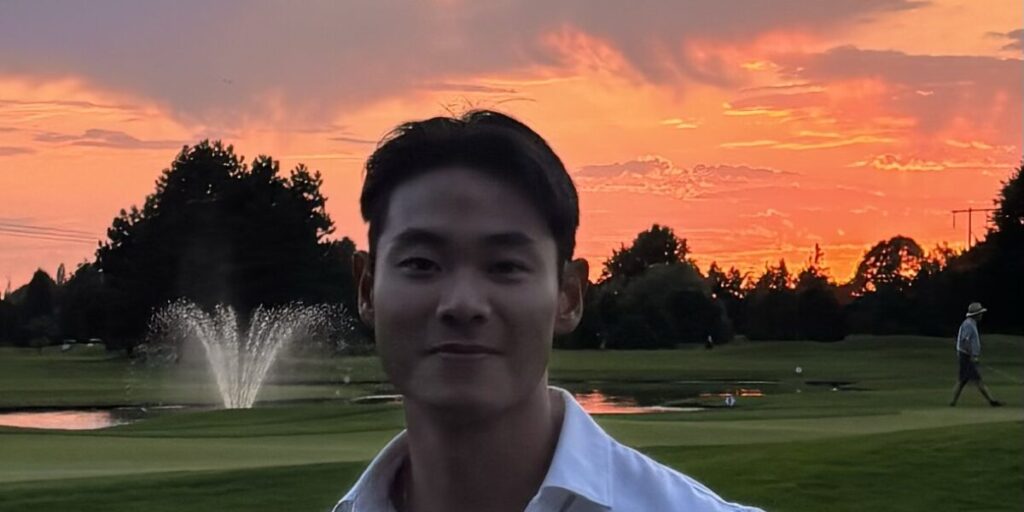 Computing instructor Edison Sie stands in front of a sunset