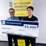 one people standing in from of one BCIT banners holding a novelty cheque