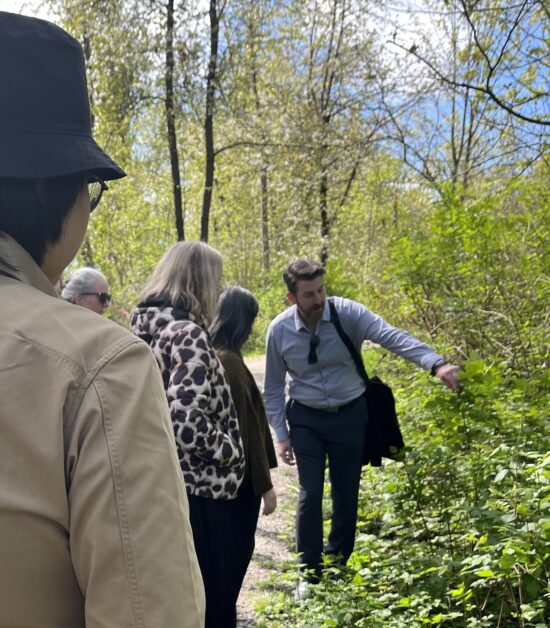 Adam Dickinson points out salmonberry bushes along the trail
