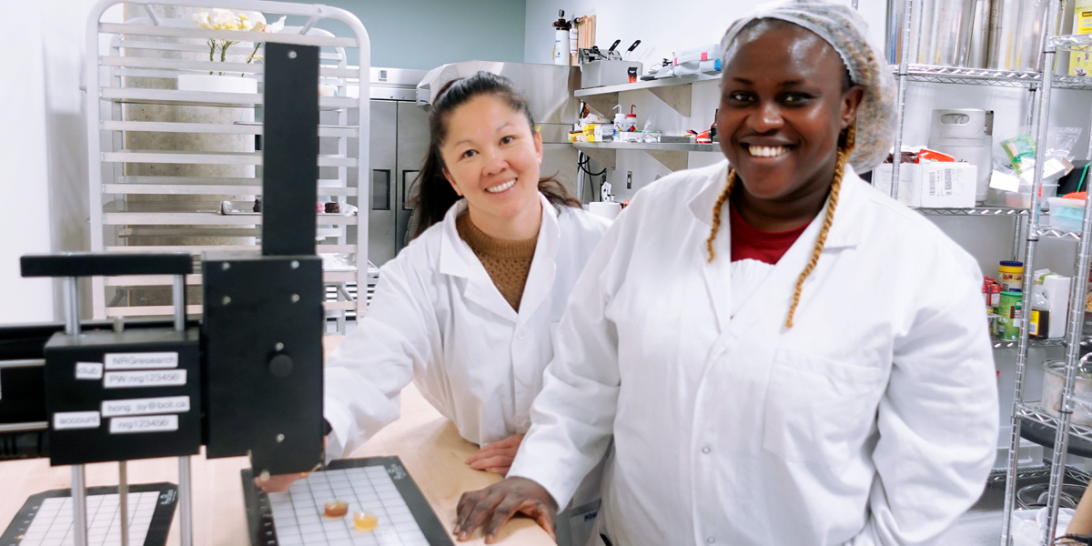 two women in lab coats in a laboratory