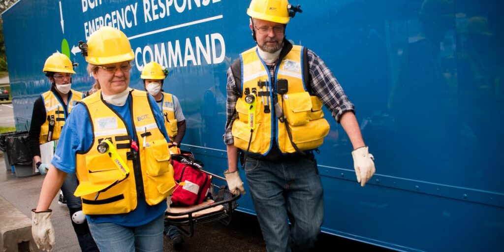 Four Light Search and Rescue members carrying a gurney