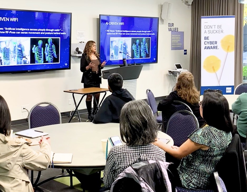 Woman presenting to a meeting room with a cybersecurity banner and information about AI wifi on screen