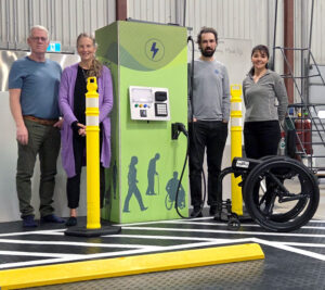 the research team standing beside the mock ev charger