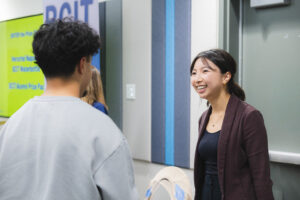 Linda Cong talking to a prospective student at the engineering panel.