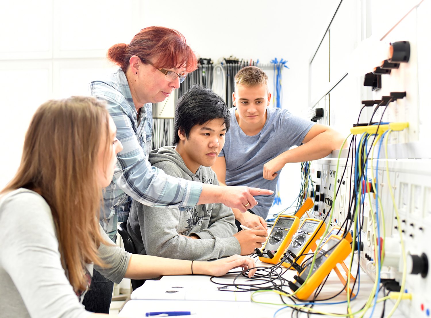 instructor demonstrating altimeters to 3 students