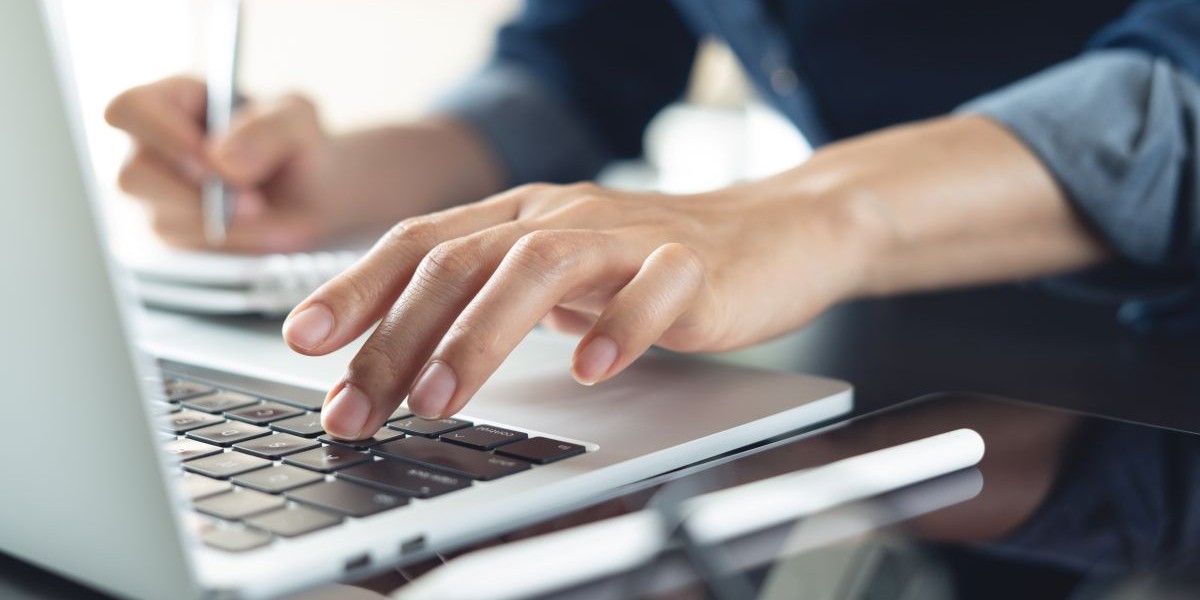 hands typing on laptop