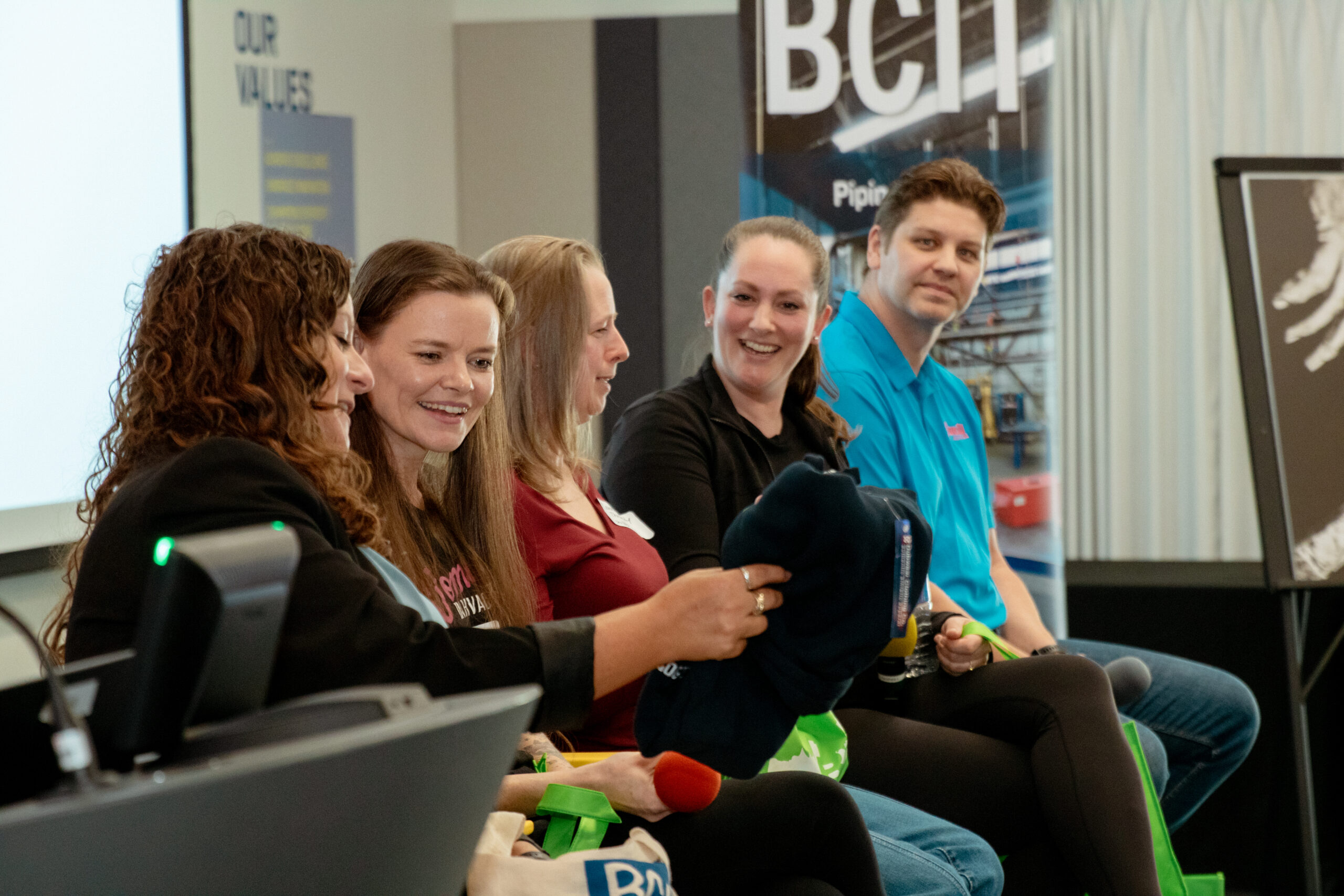 A panel of trades experts connecting and laughing