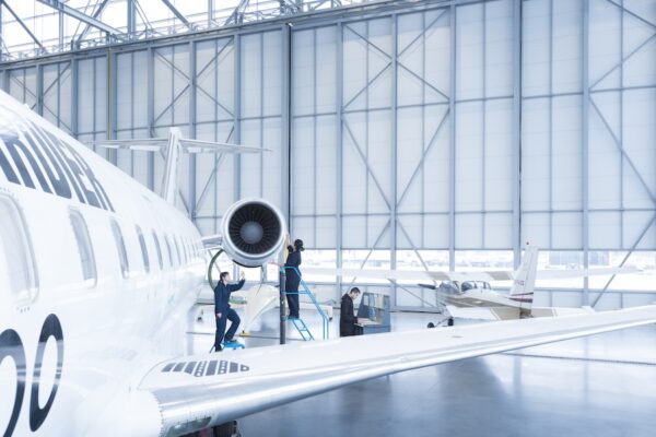 Students work on a jet turbine engine in the hangar at the BCIT Aerospace Technology Campus.