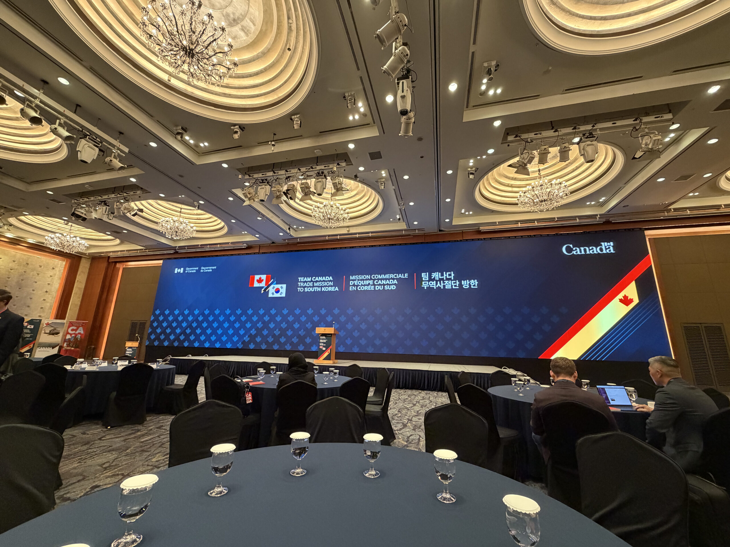 A large screening in at a conference in a ballroom setting