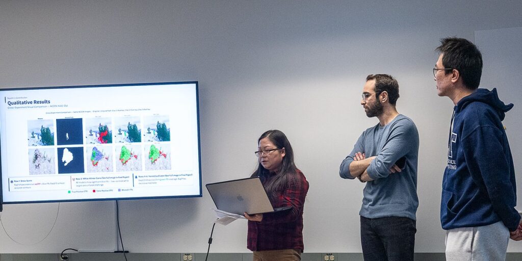 three students present data on AI algorithms in detecting camouflage