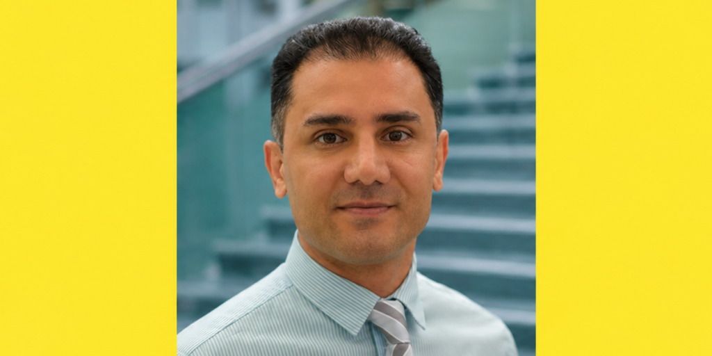 Computing faculty Saber Talazadeh wears a dress shirt and tie