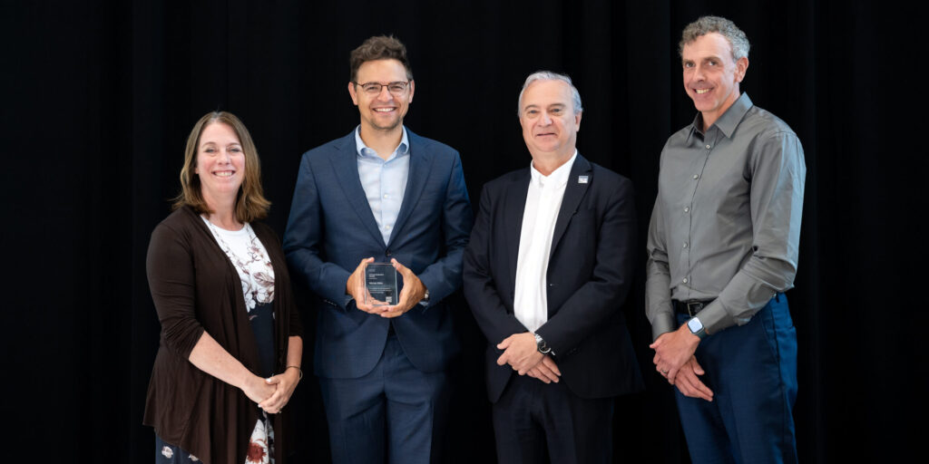 Dr. Michal Aibin receiving his 2026 Employee Excellence Award