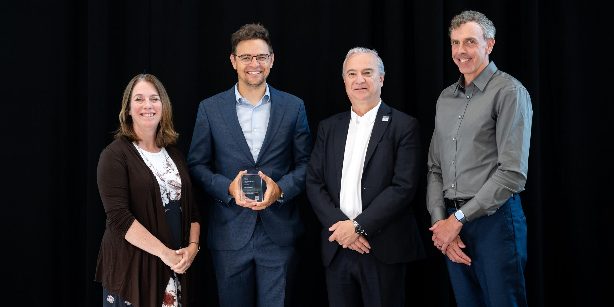 Dr. Michal Aibin receiving his 2026 Employee Excellence Award