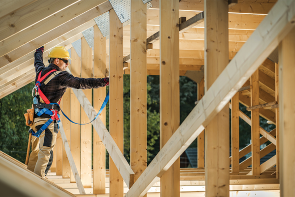 man framing a house