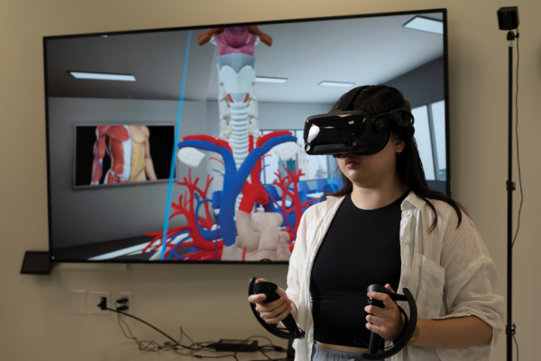 woman with virtual reality goggles and paddles with screen image in background