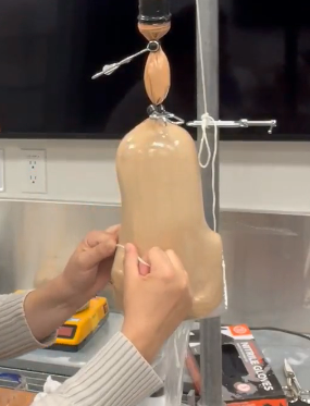 Student working on a prosthetic in lamination