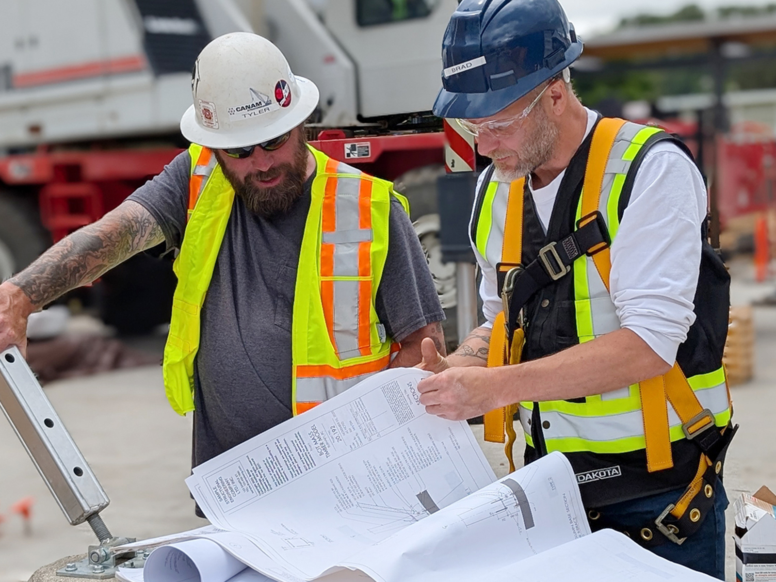 Participants reviewing construction drawings together on the practicum site.