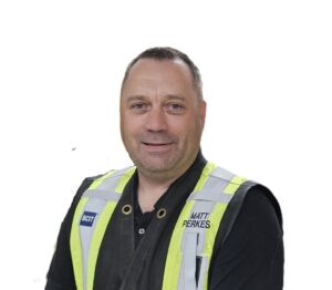 Headshot of a white man in a hi-vis vest
