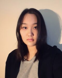 Computing grad Alina Pak with long dark hair and professional clothing