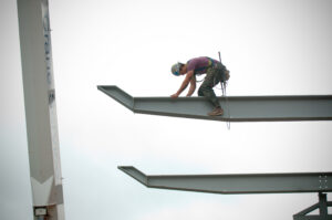 A worker balanced on a beam.